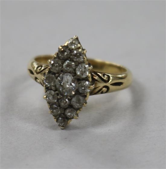 An Edwardian yellow metal and diamond set marquise shaped ring, size N.